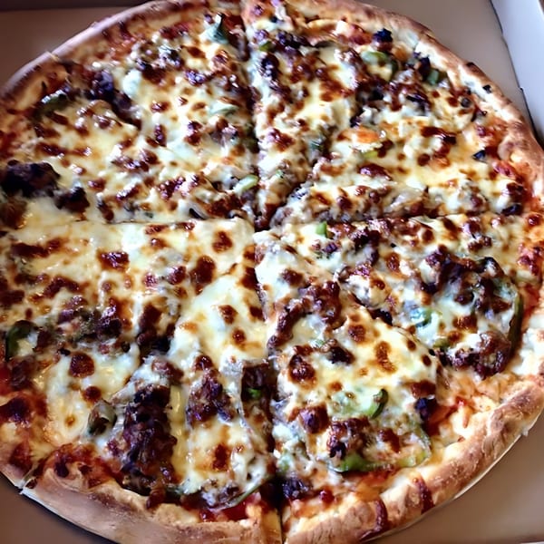 A close-up of a freshly baked, sliced pizza from The Original Village Pizza, topped with melted cheese and various toppings.