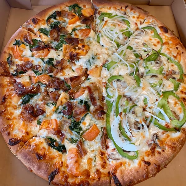 The Original Village Pizza with half bacon, spinach, and tomato, and half green pepper, onion, and mushroom.