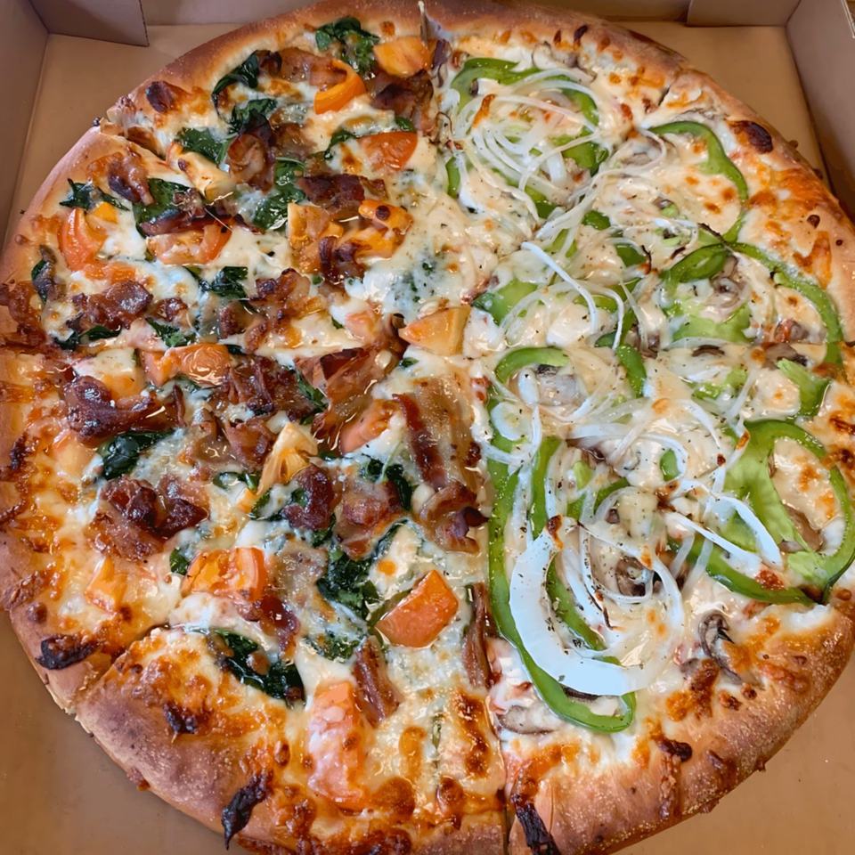 The Original Village Pizza with half bacon, spinach, and tomato, and half green pepper, onion, and mushroom.